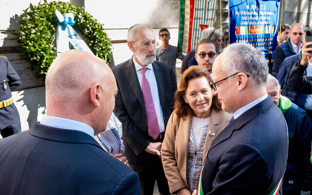 Rome Mayor Roberto Gualtieri, right, President of the Jewish Community of Rome Ruth Dureghello, second from right, and Rome's Chief Rabbi Riccardo Di Segni, center, attend a ceremony outside the Synagogue on the occasion of 79th anniversary of the Nazis deportation of Roman  Jews, in Rome, Sunday, Oct. 16, 2022.  (Mauro Scrobogna/LaPresse via AP)