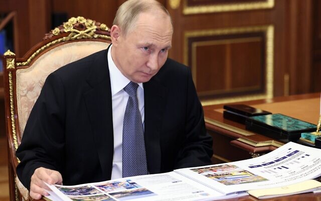 Russian President Vladimir Putin listens to Samara Region Governor Dmitry Azarov during their meeting in Moscow, Russia, Tuesday, Oct. 18, 2022. (Gavriil Grigorov, Sputnik, Kremlin Pool Photo via AP)