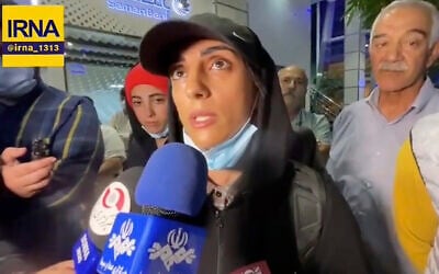 Iranian competitive climber Elnaz Rekabi speaks to journalists in Imam Khomeini International Airport in Tehran, Iran, Wednesday, Oct. 19, 2022. (IRNA via AP)