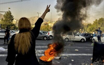 File - Iranians protest the death of 22-year-old Mahsa Amini after she was detained by the morality police, in Tehran, October 1, 2022. (AP Photo/Middle East Images, File)