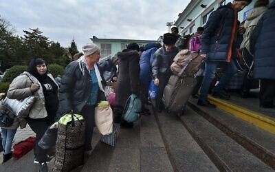 Evacuees from Kherson gather upon their arrival at the railway station in Dzhankoi, Crimea, Friday, October 21, 2022. (AP Photo)