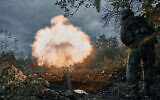 Ukrainian soldiers fire at Russian positions with a mortar in Bakhmut, Donetsk region, Ukraine, October 21, 2022. (AP Photo/LIBKOS)