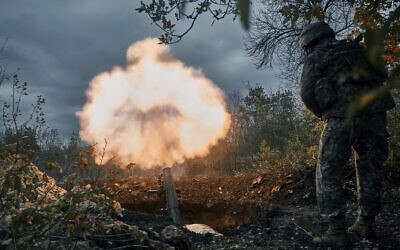 Ukrainian soldiers fire at Russian positions with a mortar in Bakhmut, Donetsk region, Ukraine, October 21, 2022. (AP Photo/LIBKOS)
