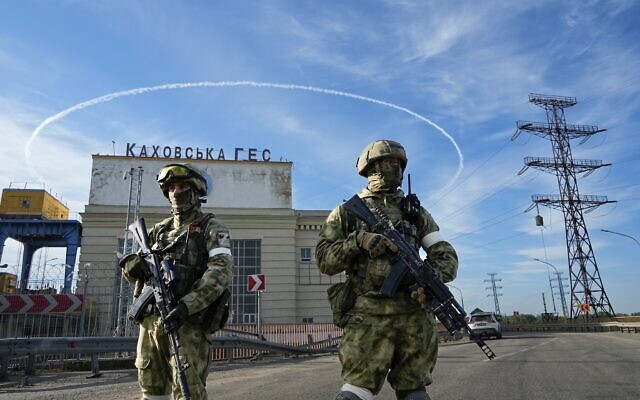 Russian troops guard an entrance of the Kakhovka Hydroelectric Station, a run-of-river power plant on the Dnieper River in Kherson region, south Ukraine, on May 20, 2022. (AP Photo, File) Russian troops guard an entrance of the Kakhovka Hydroelectric Station, a run-of-river power plant on the Dnieper River in Kherson region, south Ukraine, on May 20, 2022. (AP Photo, File)