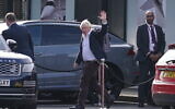 Former Prime Minister Boris Johnson arrives at Gatwick Airport in London, after traveling on a flight from the Caribbean, following the resignation of Liz Truss as prime minister, Saturday October 22, 2022. (Gareth Fuller/PA via AP)