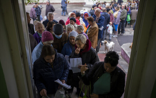 People queue to receive a daily ration of bread in a school in Mykolaiv, Ukraine, October 25, 2022. (AP Photo/Emilio Morenatti) People queue to receive a daily ration of bread in a school in Mykolaiv, Ukraine, October 25, 2022. (AP Photo/Emilio Morenatti)