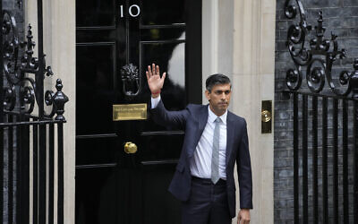 New British Prime Minister Rishi Sunak waves after arriving at Downing Street in London, after returning from Buckingham Palace where he was formally appointed to the post by Britain's King Charles III, October 25, 2022. (Kin Cheung/AP)