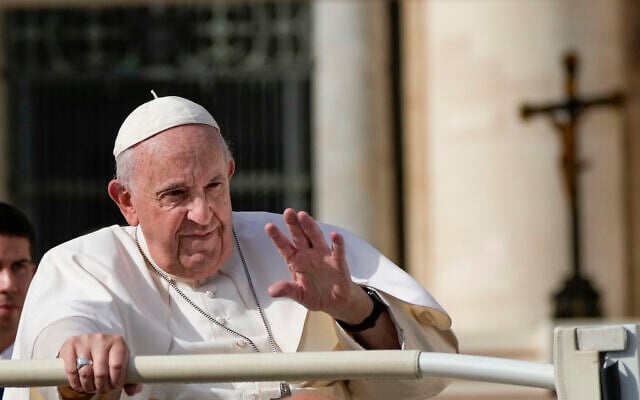 Pope Francis leaves at the end of his weekly general audience in St Peter's Square at The Vatican, Wednesday, Oct. 26, 2022. (AP Photo Alessandra Tarantino)