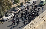 In this frame grab, from video taken by an individual not employed by The Associated Press and obtained by the AP outside Iran, Iranian police arrive to disperse a protest to mark 40 days since the death in morality police custody of 22-year-old Iranian Kurdish woman Mahsa Amini, in Tehran, Iran, October 26, 2022. (AP Photo)
