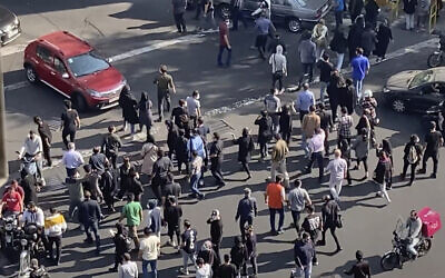 In this frame grab from video taken by an individual not employed by the Associated Press and obtained by the AP outside Iran shows people block an intersection during a protest to mark 40 days since the death in custody of 22-year-old Mahsa Amini, whose tragedy sparked Iran's biggest anti-government movement in over a decade, in Tehran, Iran, October 26, 2022. (AP Photo)