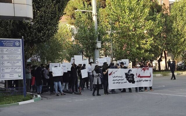In this photo taken by an individual not employed by The Associated Press and obtained by the AP outside Iran, students of Sharif University of Technology holding banners saying: 'No to mandatory hijab' and 'Dear Zhina, (Mahsa Amini's nickname), you won't die, your name will become a symbol,' during a protest sparked by the death of 22-year-old Amini in the custody of the country's morality police, in Tehran, October 7, 2022. (AP Photo) In this photo taken by an individual not employed by The Associated Press and obtained by the AP outside Iran, students of Sharif University of Technology holding banners saying: 'No to mandatory hijab' and 'Dear Zhina, (Mahsa Amini's nickname), you won't die, your name will become a symbol,' during a protest sparked by the death of 22-year-old Amini in the custody of the country's morality police, in Tehran, October 7, 2022. (AP Photo)