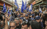 Former Israeli prime minister Benjamin Netanyahu, center, surrounded by security and his supporters visits at Hatikva Market in Tel Aviv, Israel, October 28, 2022. (AP Photo/Ariel Schalit)