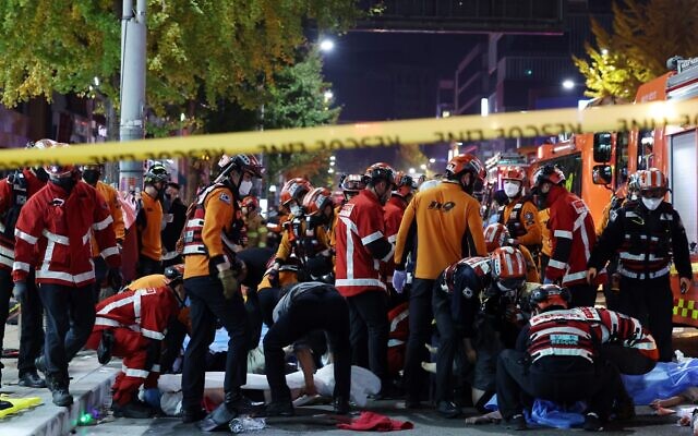 Rescue workers and firefighters work on the scene of a crushing accident in Seoul, South Korea, Saturday, October 29, 2022. (Lee Ji-eun/Yonhap via AP) Rescue workers and firefighters work on the scene of a crushing accident in Seoul, South Korea, Saturday, October 29, 2022. (Lee Ji-eun/Yonhap via AP)