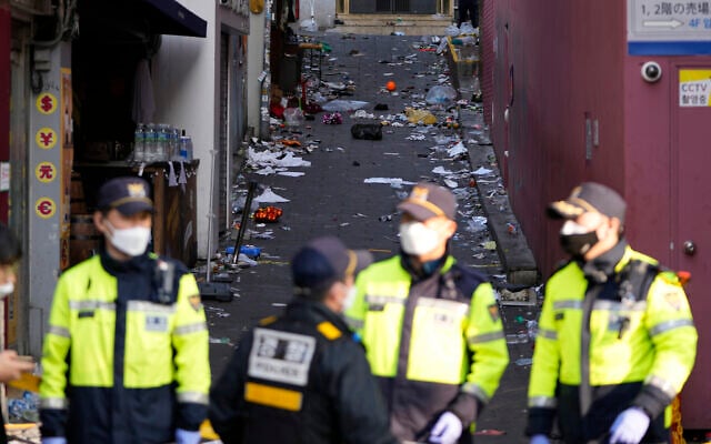 South Korean police officers stand guard at the scene of a deadly crowd crush in Seoul, South Korea, October 30, 2022.(AP Photo/Lee Jin-man) South Korean police officers stand guard at the scene of a deadly crowd crush in Seoul, South Korea, October 30, 2022.(AP Photo/Lee Jin-man)