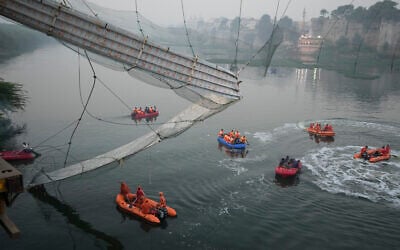 Search and rescue work is going on as a cable suspension bridge collapsed in Morbi town of western state Gujarat, India, Monday, Oct. 31, 2022. (AP/Ajit Solanki)