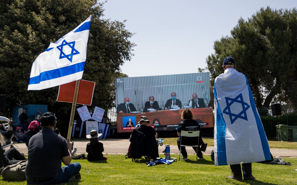 Israelis watch a High Court hearing from outside the Knesset in Jerusalem on April 3, 2020. (Yonatan Sindel/Flash90) Israelis watch a High Court hearing from outside the Knesset in Jerusalem on April 3, 2020. (Yonatan Sindel/Flash90)