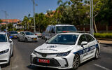 Illustrative: Firemen and police officers at the scene where a car exploded in Rishon Lezion on July 3, 2022. (Yossi Aloni/Flash90)