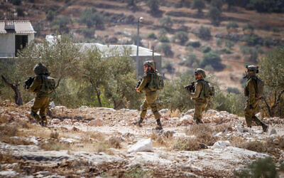 Israeli troops carry out searches following a shooting attack, in the West Bank village of Salem, near Nablus, on October 2, 2022. (Nasser Ishtayeh/Flash90) Israeli troops carry out searches following a shooting attack, in the West Bank village of Salem, near Nablus, on October 2, 2022. (Nasser Ishtayeh/Flash90)