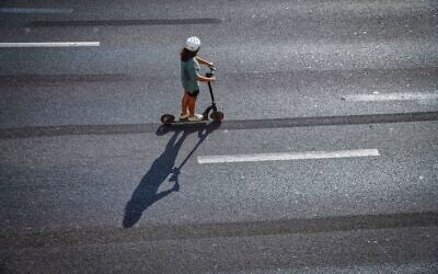 Israelis ride their bicycles along the empty Ayalon highway in Tel Aviv, on Yom Kippur, the Day of Atonement, and the holiest of Jewish holidays, October 5, 2022.  (Flash90)