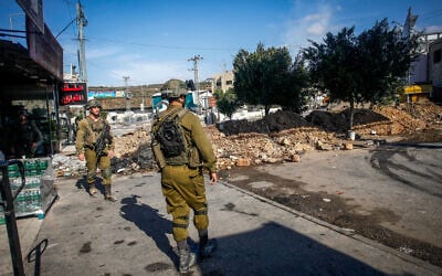 Israeli soldiers block the entrance to Deir Sharaf, near Nablus in the West Bank on October 12, 2022, (Nasser Ishtayeh/Flash90) Israeli soldiers block the entrance to Deir Sharaf, near Nablus in the West Bank on October 12, 2022, (Nasser Ishtayeh/Flash90)