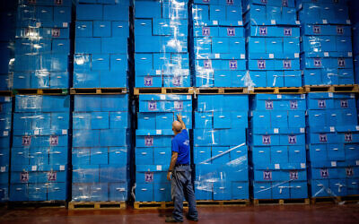 Workers prepare ballot boxes for the upcoming elections, at the Central Elections Committee warehouse in Shoham, October 12, 2022 (Yonatan Sindel/Flash90)