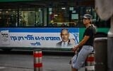 A bus with a campaign poster for opposition leader Benjamin Netanyahu's Likud party passes by the Mahane Yehuda market in Jerusalem on October 30, 2022. The poster says: "The 61st seat depends only on you!" (Olivier Ftoussi/Flash90)