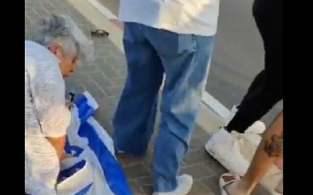 An anti-Netanyahu protester rises from the floor after being pushed by a counter-protester during a rally in Netanya, October 29, 2022. (Video screenshot; used in accordance with Clause 27a of the Copyright Law) An anti-Netanyahu protester rises from the floor after being pushed by a counter-protester during a rally in Netanya, October 29, 2022. (Video screenshot; used in accordance with Clause 27a of the Copyright Law)