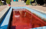 A fountain with its water colored red outside the Artists Forum at Honarmandan Park in the Iranian capital Tehran, October 7, 2022. (AFP)