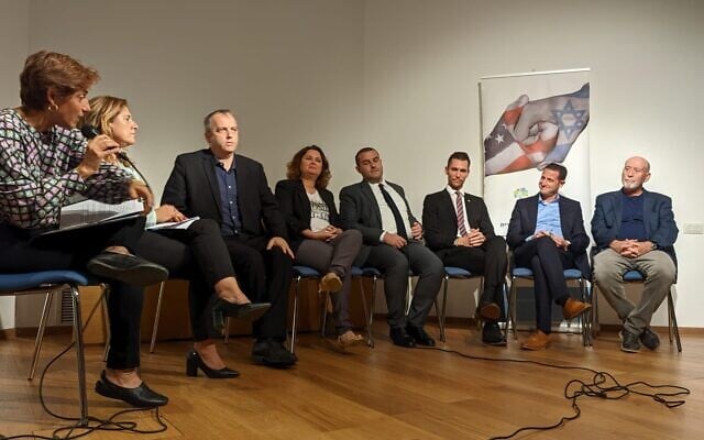 From left, journalist Nurit Canetti, Yisrael Beytenu's Sharon Roffe-Ofir, Labor's Gilad Kariv, Meretz's Michal Rozin, Jewish Home's Yomtob Kalfon, Yesh Atid's Idan Roll, Religious Zionism's Ohad Tal and Blue-and-White's Alon Tal, appear on stage during an election event on Israel-Diaspora ties at Tel Aviv's ANU Museum of the Jewish People on October 19, 2022. (Barak Sela/Reut Group/Courtesy) From left, journalist Nurit Canetti, Yisrael Beytenu's Sharon Roffe-Ofir, Labor's Gilad Kariv, Meretz's Michal Rozin, Jewish Home's Yomtob Kalfon, Yesh Atid's Idan Roll, Religious Zionism's Ohad Tal and Blue-and-White's Alon Tal, appear on stage during an election event on Israel-Diaspora ties at Tel Aviv's ANU Museum of the Jewish People on October 19, 2022. (Barak Sela/Reut Group/Courtesy)