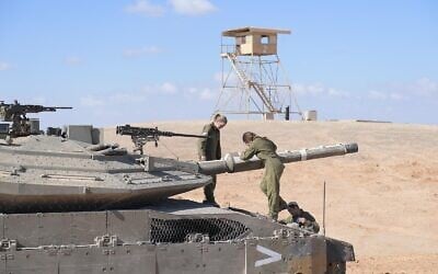 Female soldiers operate a tank in the Negev Desert, in an undated photograph. (Israel Defense Forces)
