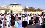 Iranians hurl stones at police station in Zahedan on September 30, 2022. (Screen capture: Twitter)