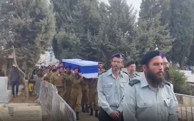 Mourners at the funeral ceremony for Staff Sgt. Ido Baruch, on October 12, 2022, in Gedera. (Screenshot) Mourners at the funeral ceremony for Staff Sgt. Ido Baruch, on October 12, 2022, in Gedera. (Screenshot)