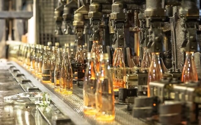 An undated photo of glass bottle manufacturing at the Phoenicia factory in Yeruham, southern Israel. (Yoav Weiss, Airovation Technologies) An undated photo of glass bottle manufacturing at the Phoenicia factory in Yeruham, southern Israel. (Yoav Weiss, Airovation Technologies)