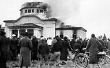 Illustrative: In Graz, Austria, onlookers watch a smoldering synagogue the morning after Kristallnacht, November 10, 1938. (public domain)