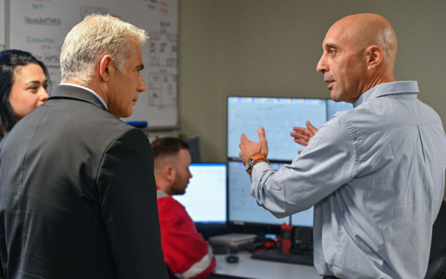 Prime Minister Yair Lapid (L) tours the Karish natural gas field in the Mediterranean Sea, off Israel's northern coast, October 30, 2022. (Kobi Gideon/GPO)