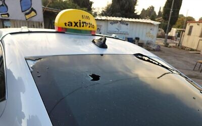 A taxi that was apparently hit by gunfire on a West Bank road, October 2, 2022. (Samaria Regional Council)