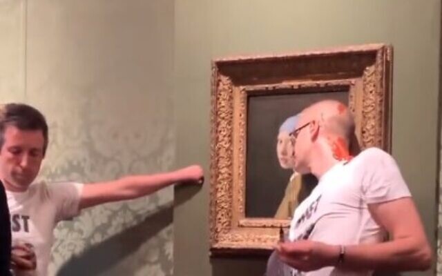 Climate activists try to deface the Johannes Vermeer masterpiece 'Girl with a Pearl Earring' on October 27, 2022 (screen capture/Twitter)
