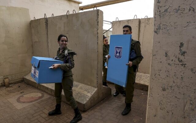 Israeli soldiers arrive with election equipment to facilitate early voting for military members in the Israeli general elections, at the Har Dov military base on Mount Hermon on the Golan Heights on October 31, 2022. (Photo by JALAA MAREY / AFP) Israeli soldiers arrive with election equipment to facilitate early voting for military members in the Israeli general elections, at the Har Dov military base on Mount Hermon on the Golan Heights on October 31, 2022. (Photo by JALAA MAREY / AFP)