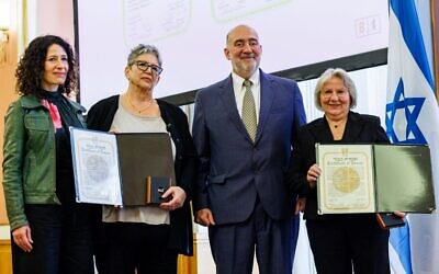Israel's Ambassador to Germany Ron Prosor (2nd-R) and Berlin's Deputy Mayor Bettina Jarasch (L) present Anne-Marget Schmid (2ndL) and Gundela Suter, descendants and grand-daughters of four German 'Righteous Among the Nations', with medals from Jerusalem's Yad Vashem Holocaust memorial during a posthumous ceremony in their honor at the City Hall of Berlin, on November 2, 2022. (Jens Schlueter/AFP)