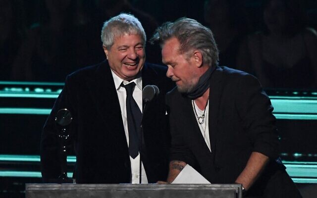 US singer-songwriter John Mellencamp (R) gives the Ahmet Ertegun Award to lawyer Allen Grubman during the 37th Annual Rock and Roll Hall of Fame Induction Ceremony at the Microsoft Theatre on November 5, 2022, in Los Angeles, California. (VALERIE MACON / AFP) US singer-songwriter John Mellencamp (R) gives the Ahmet Ertegun Award to lawyer Allen Grubman during the 37th Annual Rock and Roll Hall of Fame Induction Ceremony at the Microsoft Theatre on November 5, 2022, in Los Angeles, California. (VALERIE MACON / AFP)