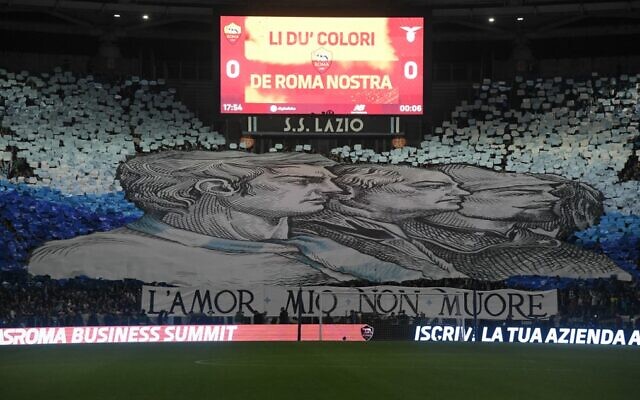 A giant tifo unfurled by Lazio fans, reading "my love will not die." is displayed in a tribune prior to the Italian Serie A soccer match between AS Rome and Lazio on November 6, 2022 at the Olympic stadium in Rome. (Tiziana Fabi/AFP) A giant tifo unfurled by Lazio fans, reading "my love will not die." is displayed in a tribune prior to the Italian Serie A soccer match between AS Rome and Lazio on November 6, 2022 at the Olympic stadium in Rome. (Tiziana Fabi/AFP)