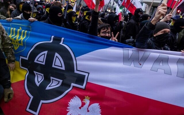 A Celtic Cross is seen on a banner with the Polish and Ukrainian national colors, as participants attend Poland's Independence Day march organized by nationalist groups in Warsaw on November 11, 2022. (Wojtek Radwanski/AFP) A Celtic Cross is seen on a banner with the Polish and Ukrainian national colors, as participants attend Poland's Independence Day march organized by nationalist groups in Warsaw on November 11, 2022. (Wojtek Radwanski/AFP)