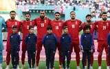 Iran players listen to the national anthem ahead of the Qatar 2022 World Cup Group B football match between England and Iran at the Khalifa International Stadium in Doha on November 21, 2022. (FADEL SENNA/AFP)