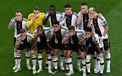 German soccer players cover their mouths as they pose for a group picture during the Qatar 2022 World Cup Group E football match between Germany and Japan at the Khalifa International Stadium in Doha on November 23, 2022. (Anne-Christine POUJOULAT/AFP) German soccer players cover their mouths as they pose for a group picture during the Qatar 2022 World Cup Group E football match between Germany and Japan at the Khalifa International Stadium in Doha on November 23, 2022. (Anne-Christine POUJOULAT/AFP)