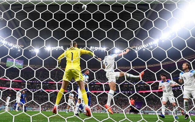 England's goalkeeper #01 Jordan Pickford and England's defender #06 Harry Maguire jump for the ball during the Qatar 2022 World Cup Group B football match between England and USA at the Al-Bayt Stadium in Al Khor, north of Doha on November 25, 2022. (Odd ANDERSEN / AFP)