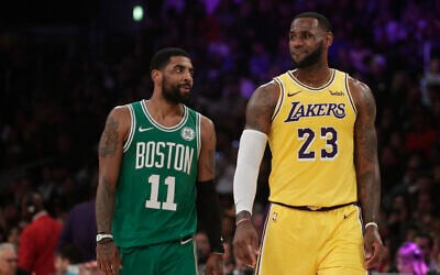 Los Angeles Lakers' LeBron James, right, and Boston Celtics' Kyrie Irving chat during the first half of an NBA basketball game, March 9, 2019, in Los Angeles. (AP Photo/Jae C. Hong)