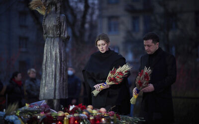 Ukrainian President Volodymyr Zelenskyy and his wife Olena visit a monument for Holodomor victims during a commemoration ceremony marking the 88th anniversary of the Great Famine of 1932-33, in which millions died of hunger, in Kyiv, Ukraine, Saturday Nov. 27, 2021. Church bells tolled, candles flickered and national flags, adorned with black ribbons, flew in the Ukrainian capital Kyiv Saturday as the country marked the anniversary of the start of a Soviet-era famine.(Ukrainian Presidential Press Office via AP)