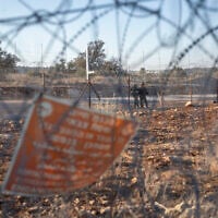 Israeli soldiers guard a section of Israel's security barrier, in the West Bank village of Nilin, west of Ramallah, November 7, 2021. (AP Photo/Nasser Nasser, File)