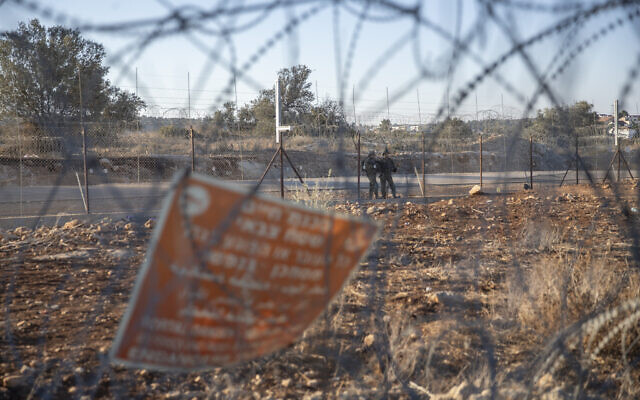 Israeli army soldiers guard a section of Israel's separation barrier, in the West Bank village of Nilin, west of Ramallah, November 7, 2021. (AP Photo/Nasser Nasser, File) Israeli army soldiers guard a section of Israel's separation barrier, in the West Bank village of Nilin, west of Ramallah, November 7, 2021. (AP Photo/Nasser Nasser, File)