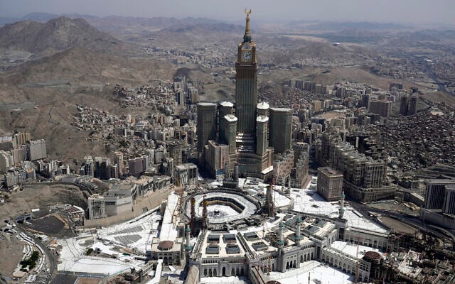 An aerial view shows the clock tower over the Grand mosque as Muslim pilgrims walk around the Kaaba, the black cube seen at center inside the grand mosque, during the annual hajj pilgrimage in Mecca, Saudi Arabia, July 10, 2022 (AP Photo/Amr Nabil)